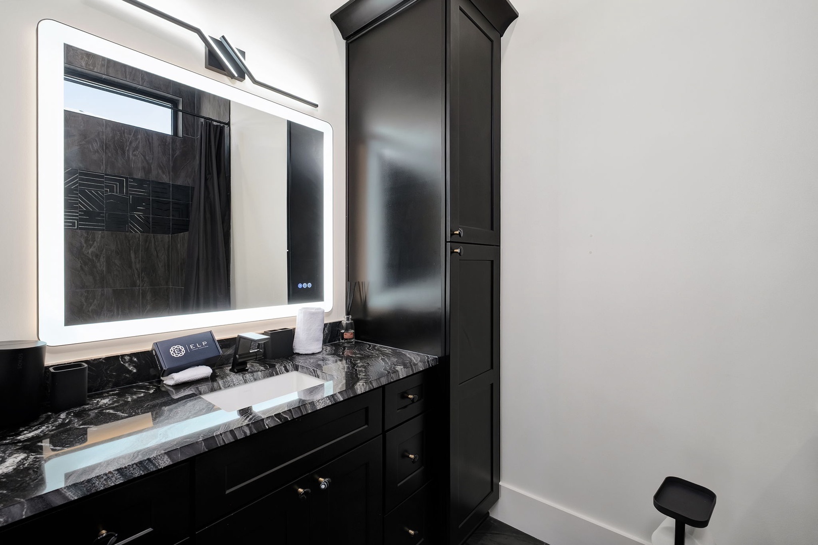 Step into your sleek private bathroom featuring LED-lit mirrors, elegant marble countertops, and premium fixtures for your comfort.