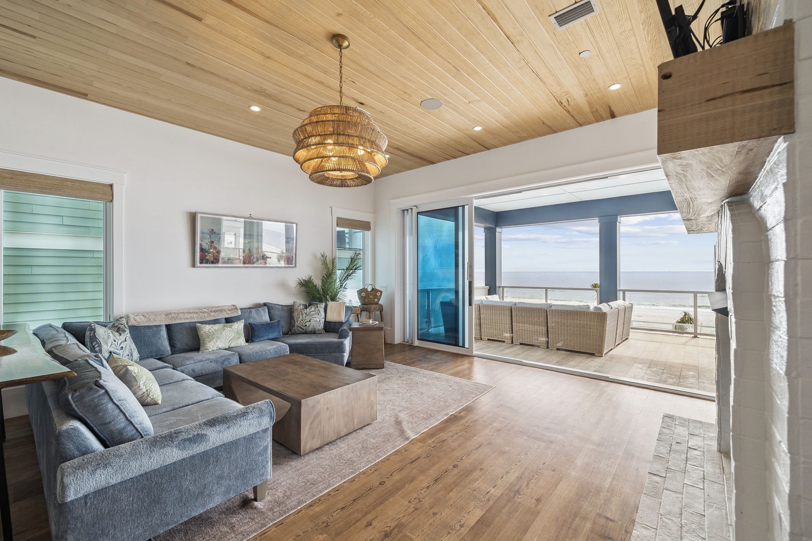 Unwind in your stunning living space with ocean views, warm wood touches, and coastal elegance flowing onto the private balcony.