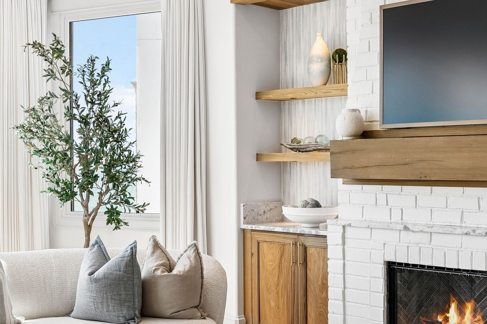 Cozy up by the warmth of your fireplace, surrounded by serene coastal-inspired décor and soft natural light. Your perfect retreat awaits with elegant, timeless touches throughout.