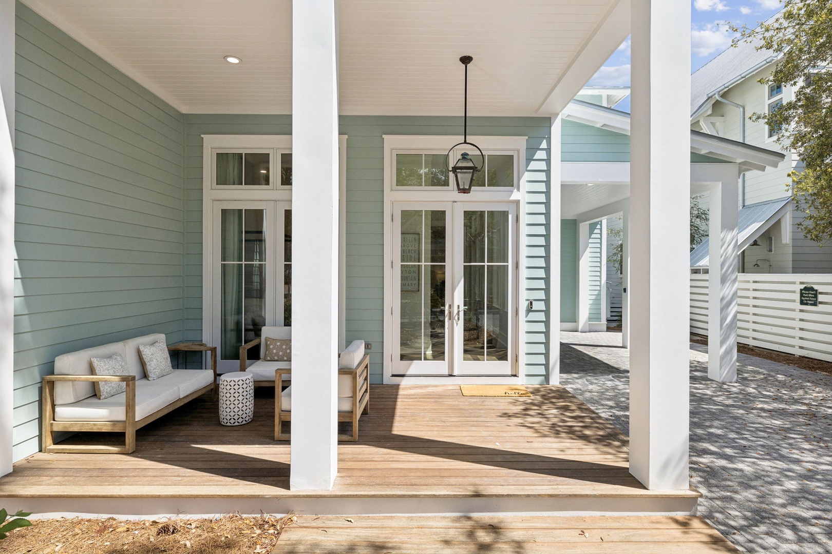 Your covered front porch welcomes you with coastal charm and comfortable seating for morning coffee or evening relaxation.