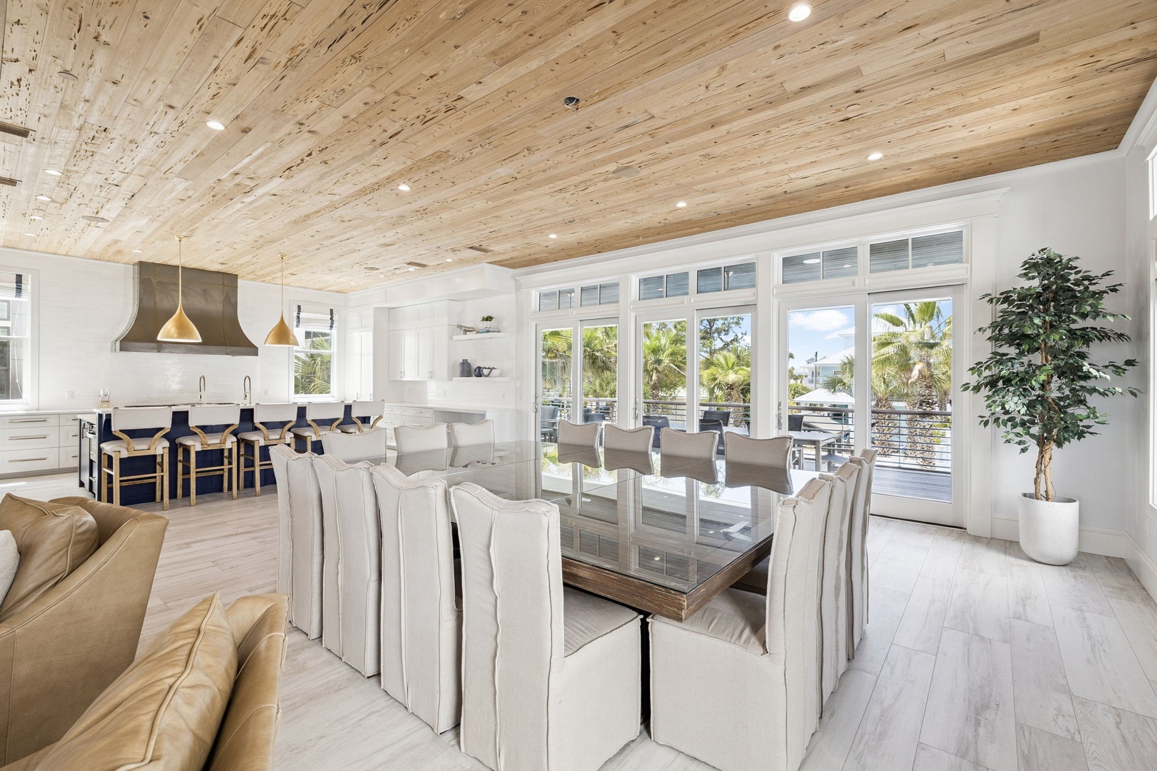 Your elegant dining space flows seamlessly into the modern kitchen, beneath stunning reclaimed wood ceilings that add warmth to every meal.