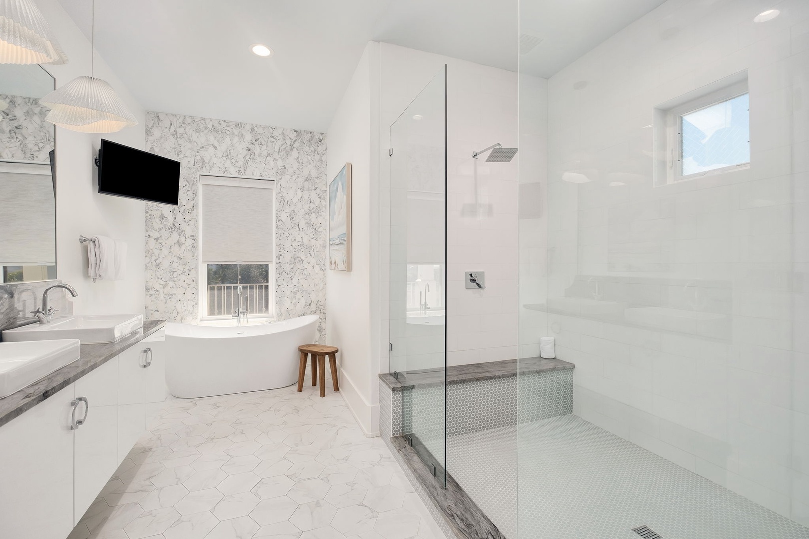 Luxurious spa-like bathroom with marble finishes, soaking tub, and rainfall shower awaits your relaxation.
