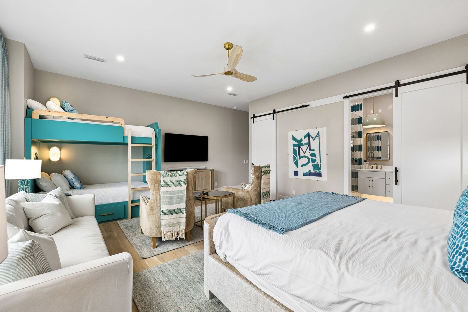 Unwind in your coastal-inspired bedroom with a cozy queen bed and fun bunk beds—perfect for families. The private ensuite and seating area make this your personal retreat.
