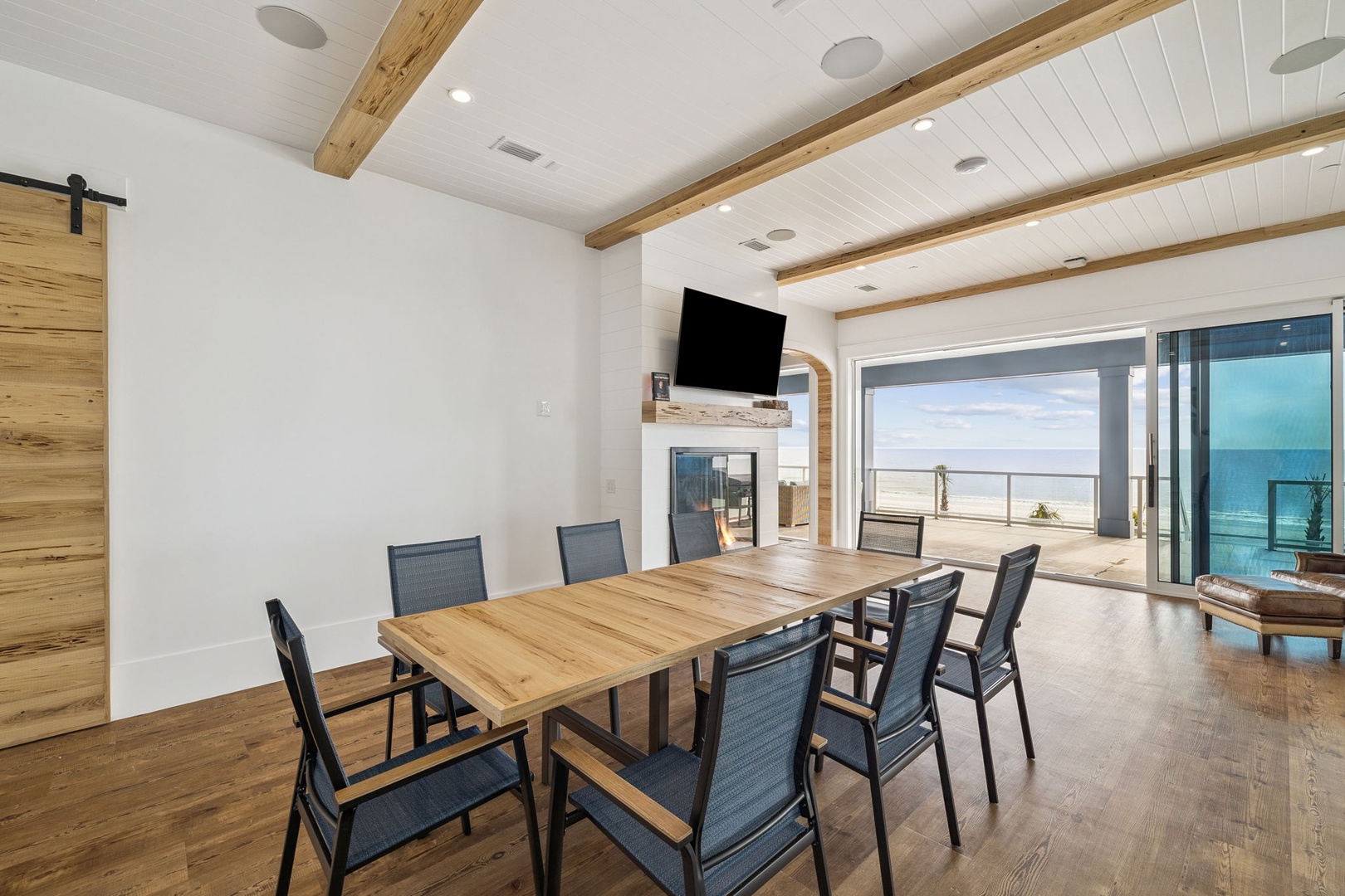 Gather around this stunning dining table with ocean views streaming through floor-to-ceiling windows, creating the perfect backdrop for memorable meals.