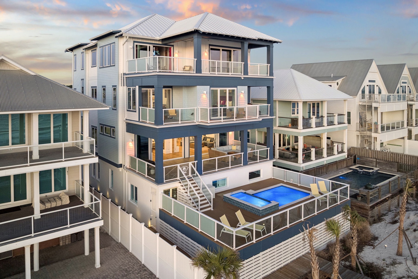 Modern beachfront property featuring a private pool and multiple outdoor decks in a coastal community setting.