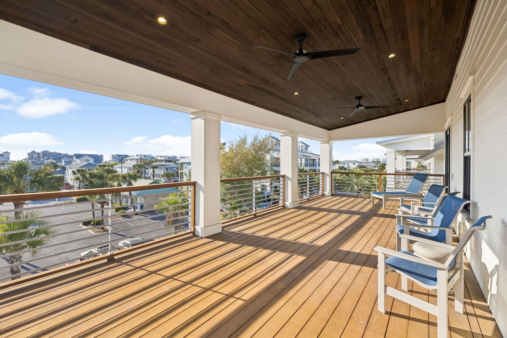 Unwind on your expansive wooden deck where ceiling fans create gentle breezes and comfortable seating awaits your morning coffee or sunset cocktails.