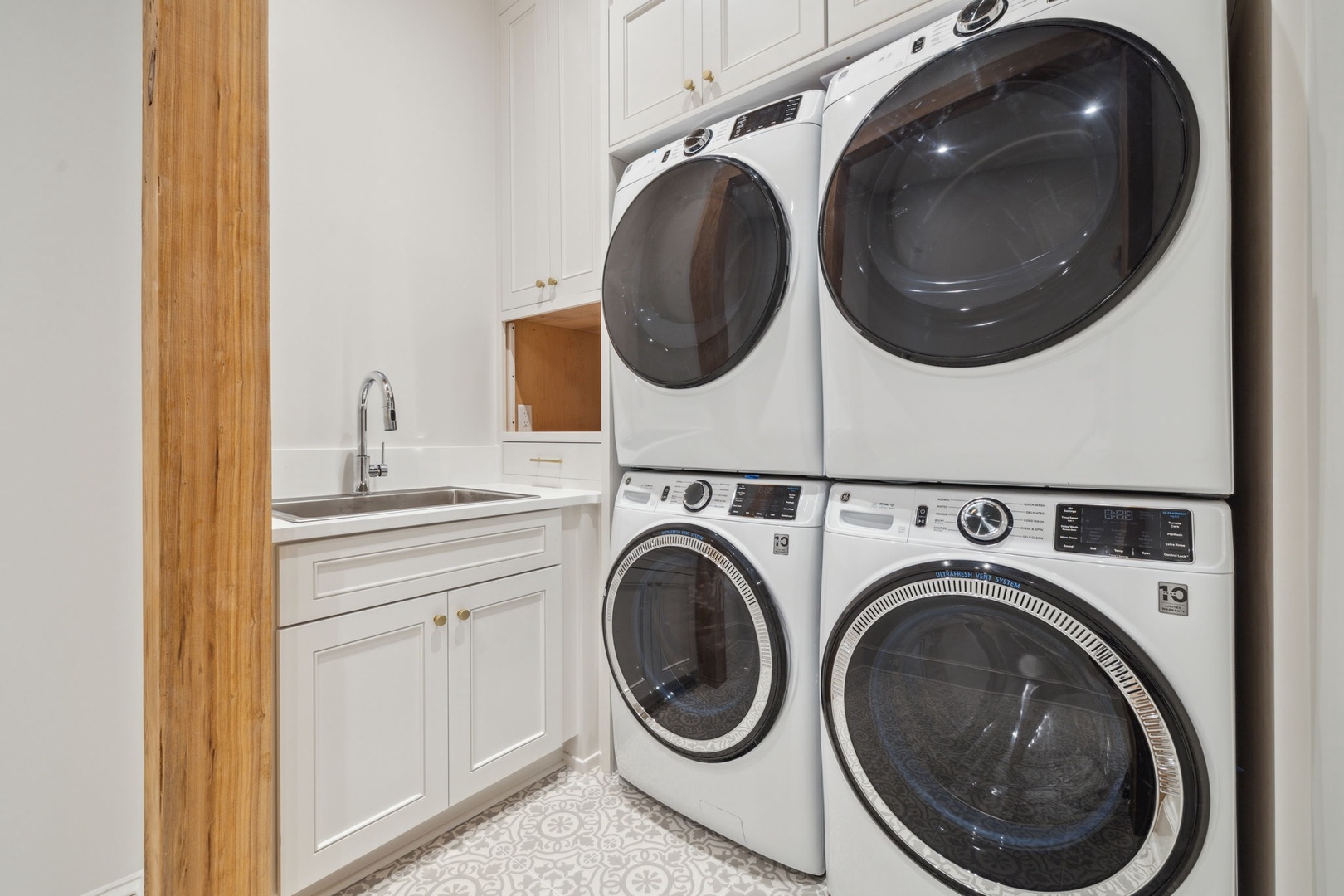 Your dedicated laundry room features dual washers and dryers, perfect for keeping up with linens and towels during your stay. A utility sink and ample storage add convenience for longer trips.
