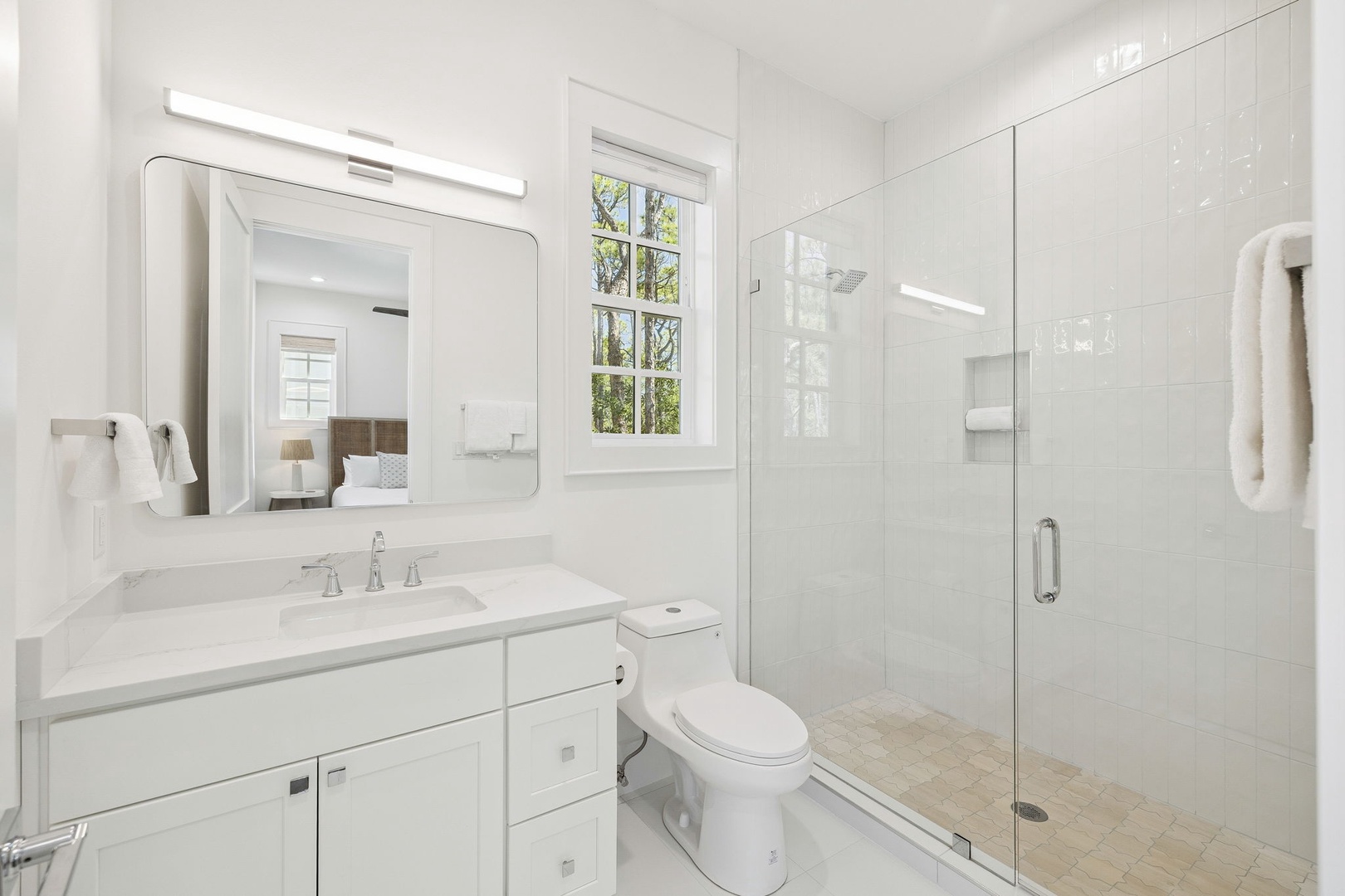 Step into your pristine ensuite bathroom with walk-in shower and elegant marble countertops—perfect for refreshing after busy days exploring.