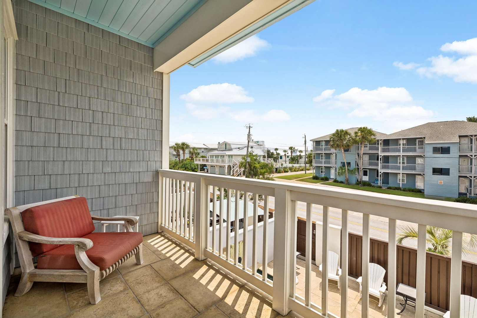 Step onto your private balcony and soak in the sunny coastal neighborhood. With palm trees swaying and blue skies above, it's the perfect spot to sip morning coffee or unwind after a beach day.