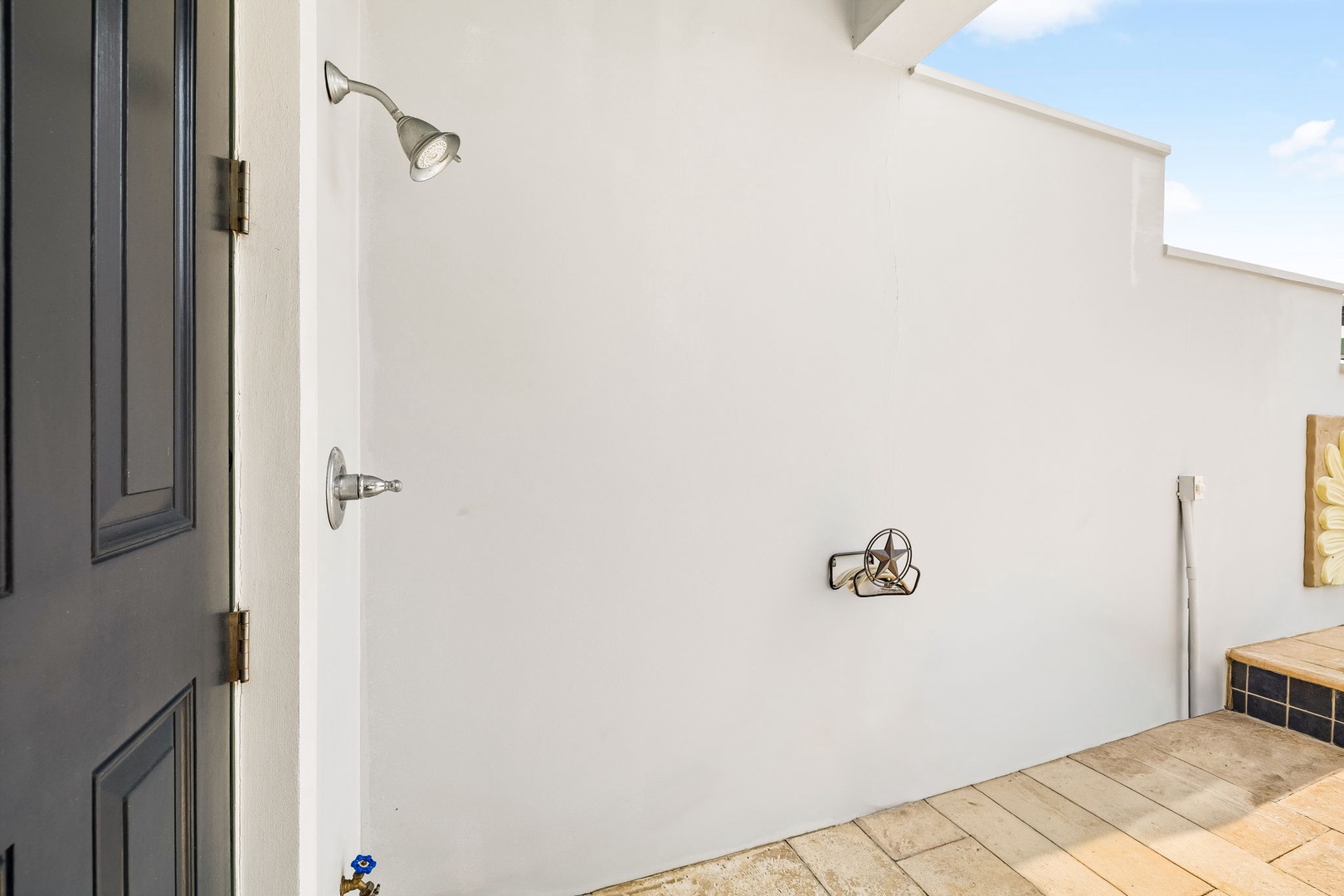 Your private outdoor shower awaits—rinse off under the open sky after a day at the beach.