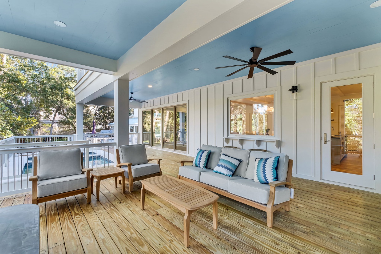 Unwind on your private covered deck with comfortable seating and ceiling fans, perfect for morning coffee or evening relaxation.
