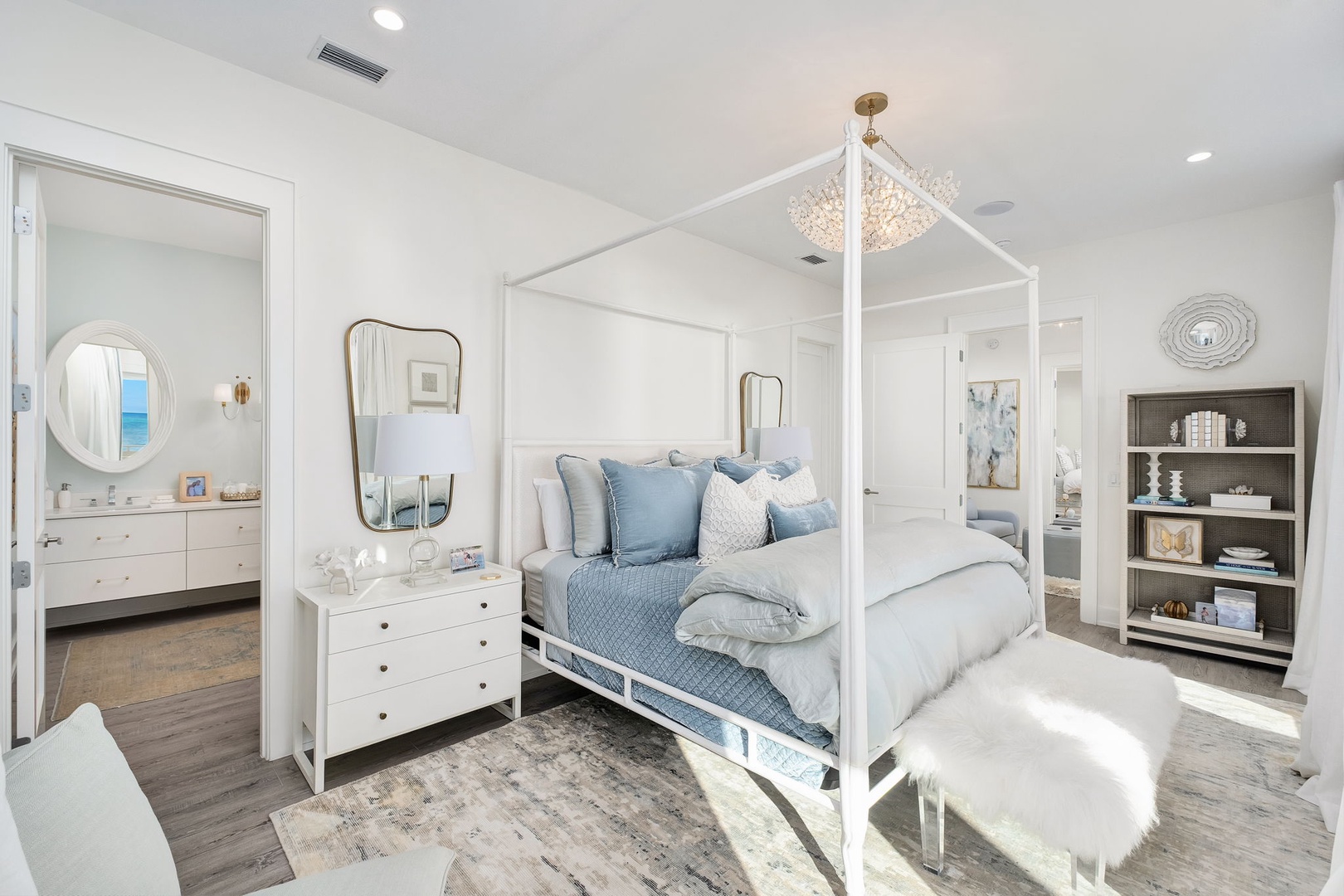 Drift off under a chandelier in your serene canopy bed, with soft blues and whites creating a peaceful retreat. Your ensuite bath awaits just steps away.