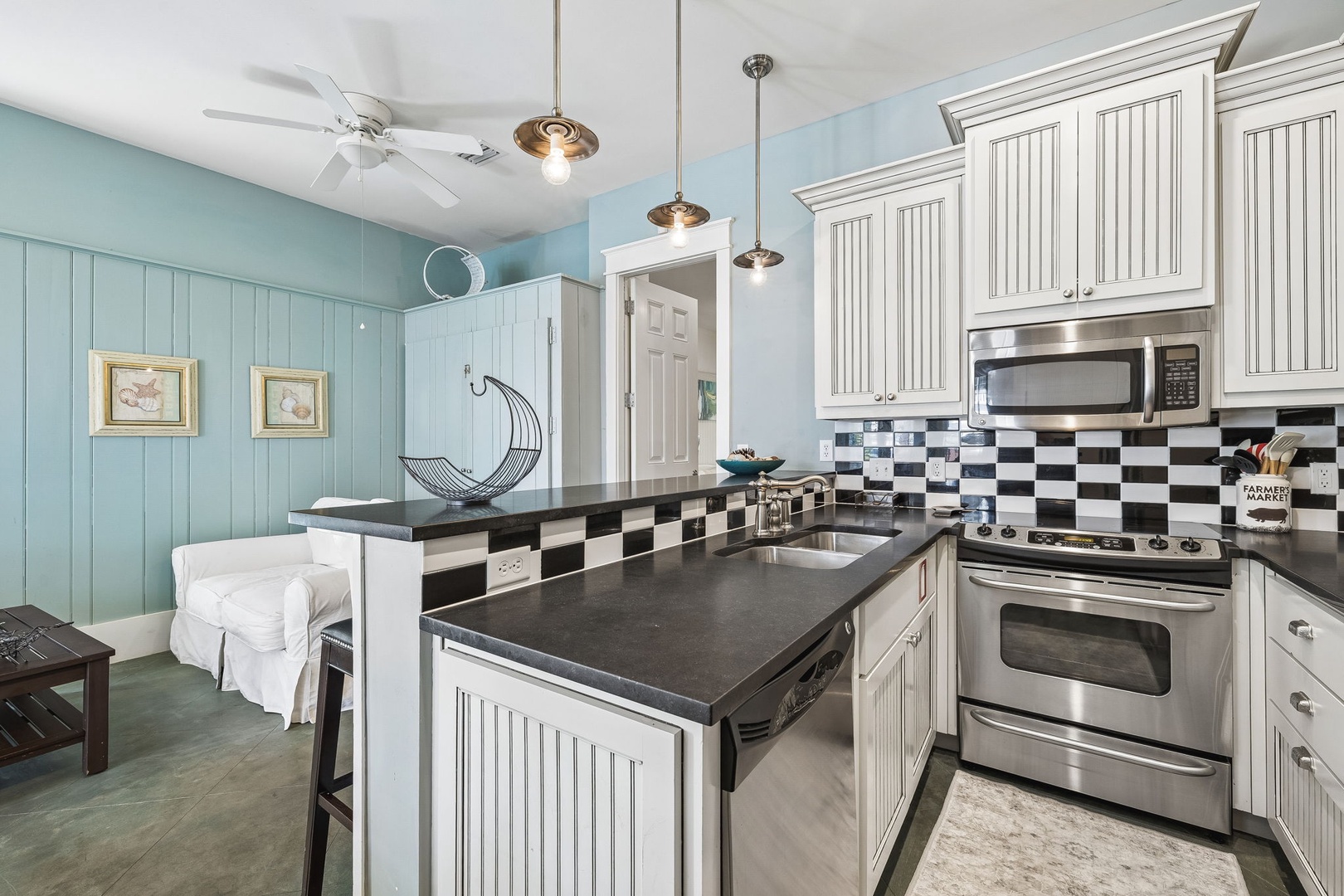 Your fully equipped kitchen invites you to prepare meals surrounded by coastal-inspired décor, sleek countertops, and modern stainless-steel appliances, all bathed in natural light.