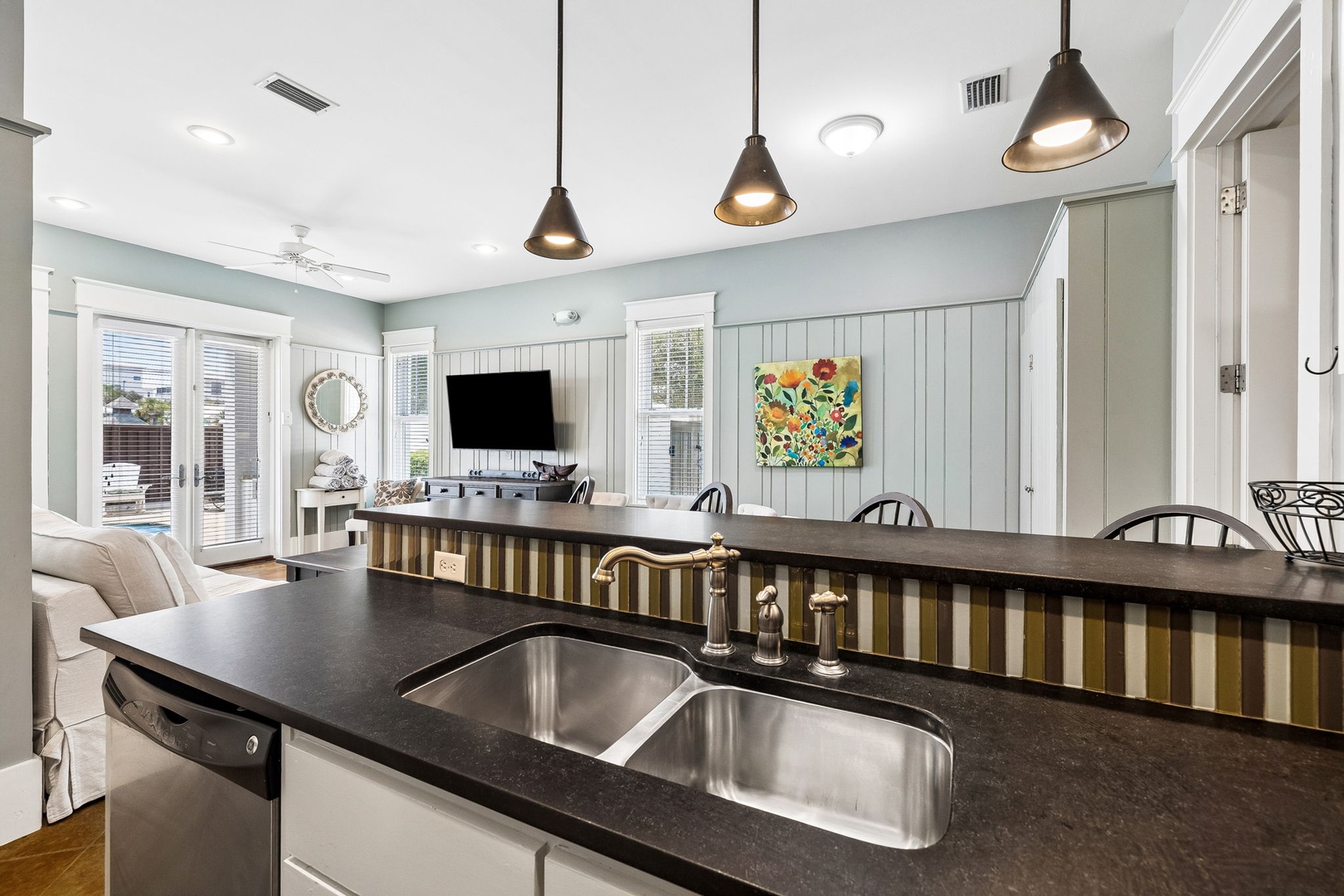 Gather around this bright, open-concept kitchen and living area where your group can cook, dine, and relax together. Natural light floods in through glass doors leading to your private patio.