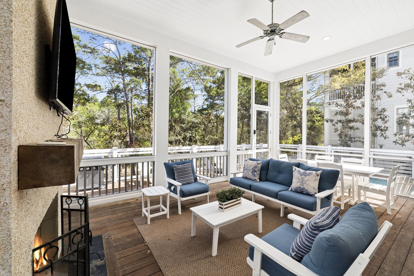 Relax in your screened porch with cozy seating, fireplace warmth, and peaceful treetop views.
