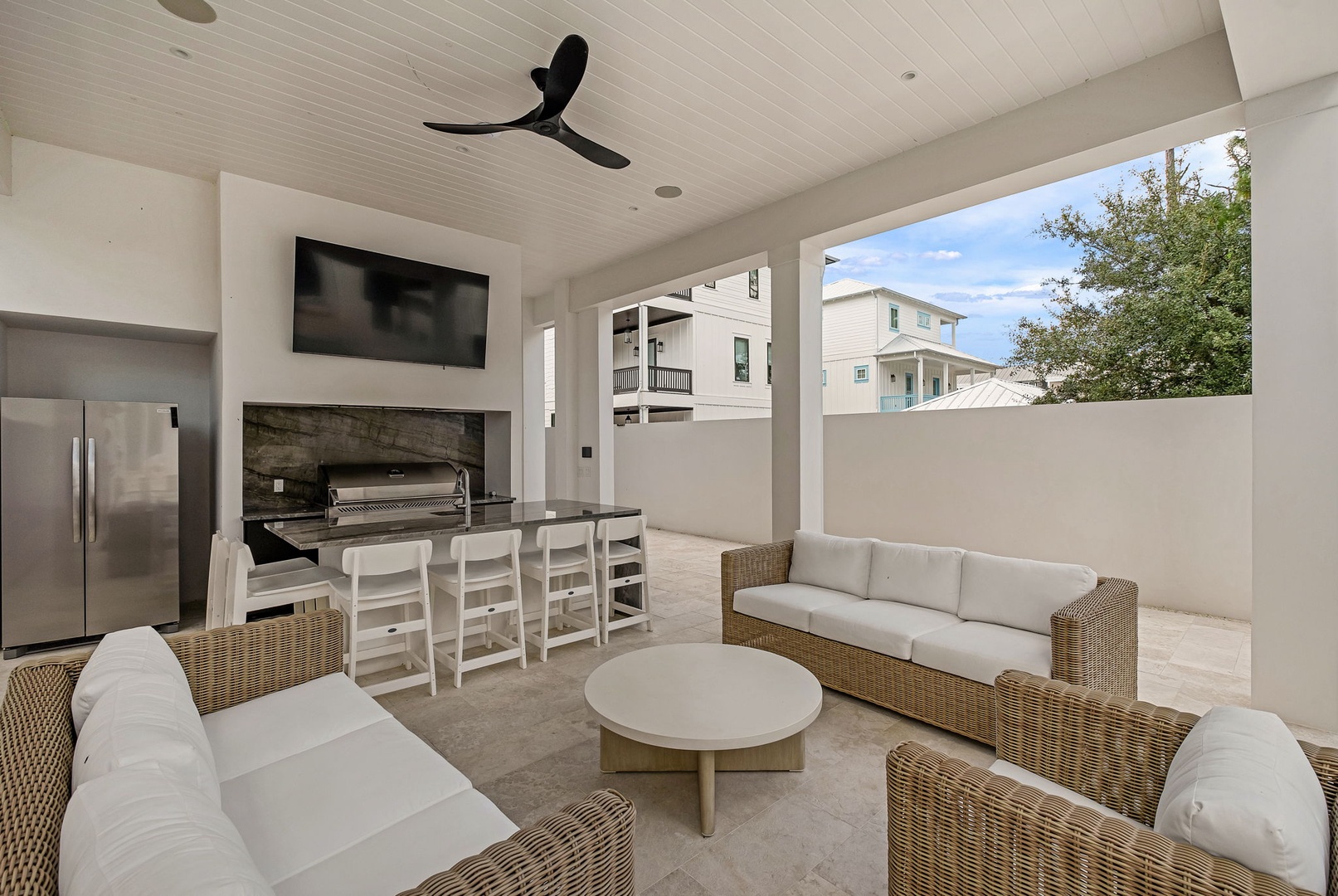 Your open-air oasis awaits, complete with a built-in grill, cozy outdoor lounge seating, and a dining area perfect for entertaining under the Florida sky.