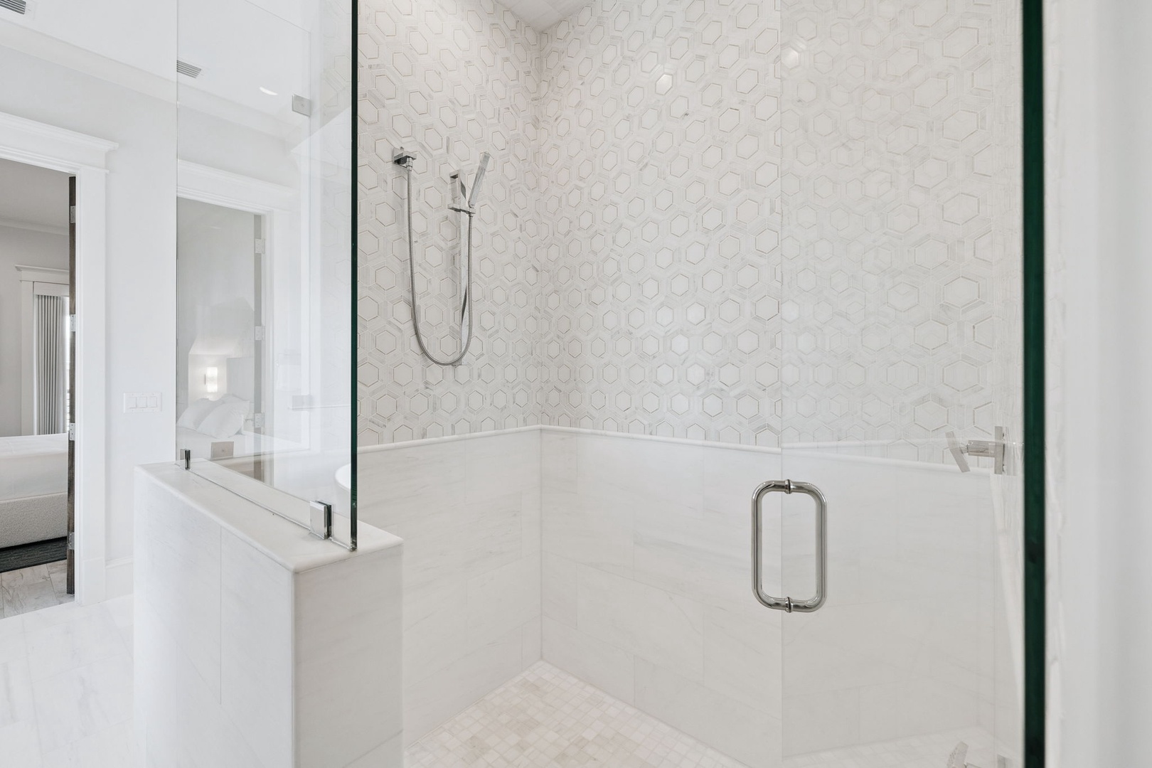 Step into your elegant shower sanctuary with stunning hexagonal tile work and premium glass enclosure for pure relaxation.