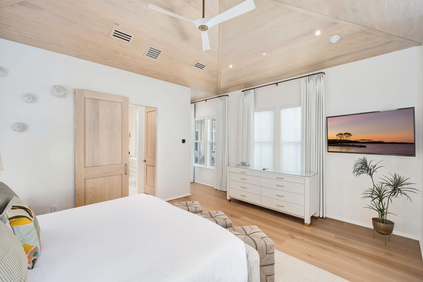 Unwind in your serene bedroom with soaring vaulted ceilings, plenty of natural light, and elegant coastal touches that create the perfect space to rest and recharge.