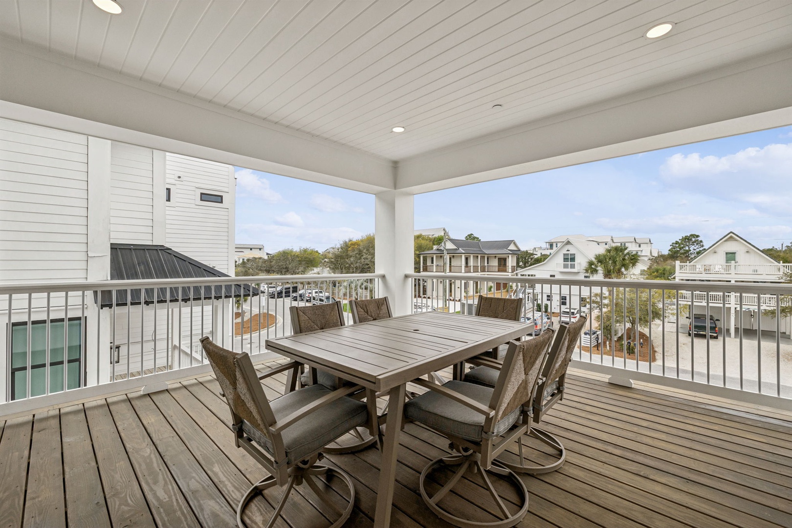 Gather around this spacious deck table where you can savor meals while overlooking the charming neighborhood below.