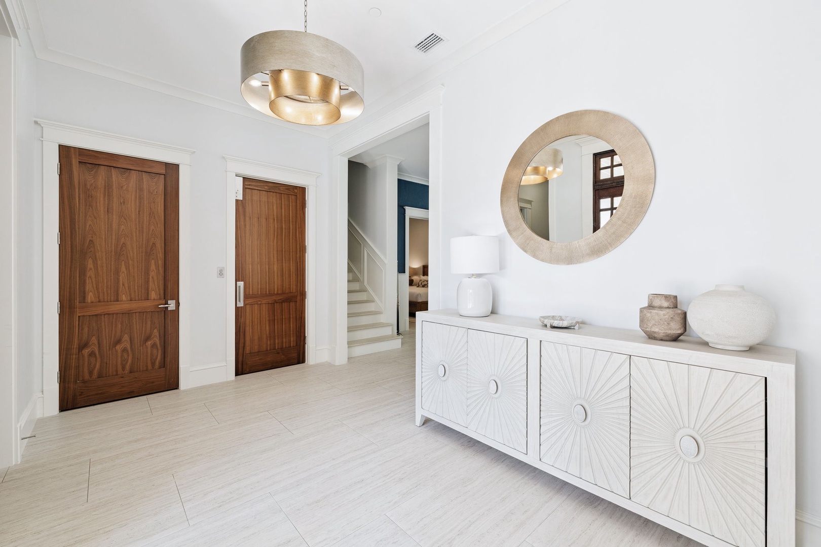 You'll be greeted by elegant contemporary styling with warm wood accents and designer lighting that creates a welcoming first impression.