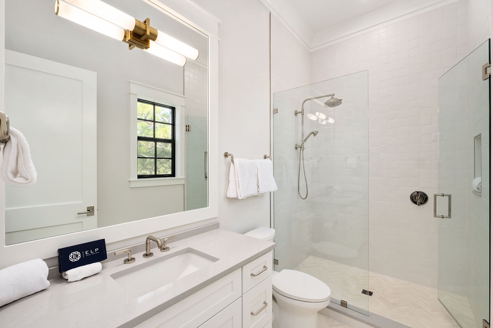 Refresh in your pristine bathroom featuring a spacious glass shower, elegant vanity, and luxurious finishes that create a spa-like retreat.