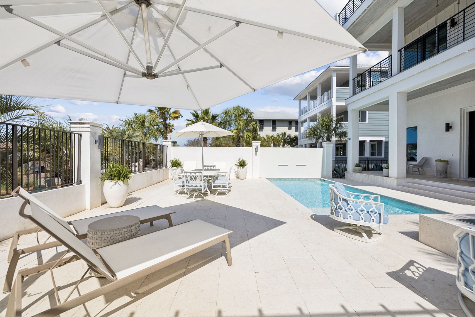 Soak up the sunshine on your private pool deck, where comfortable loungers and dining space create your perfect tropical retreat.