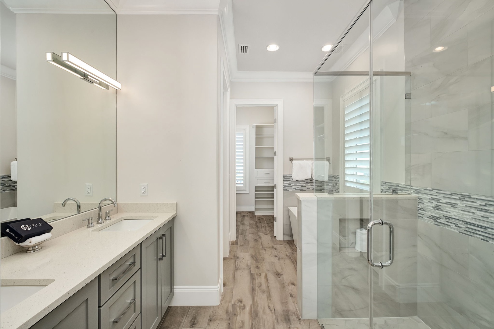 Your spacious ensuite bathroom features elegant marble finishes, a walk-in shower, and modern touches that create a spa-like retreat.