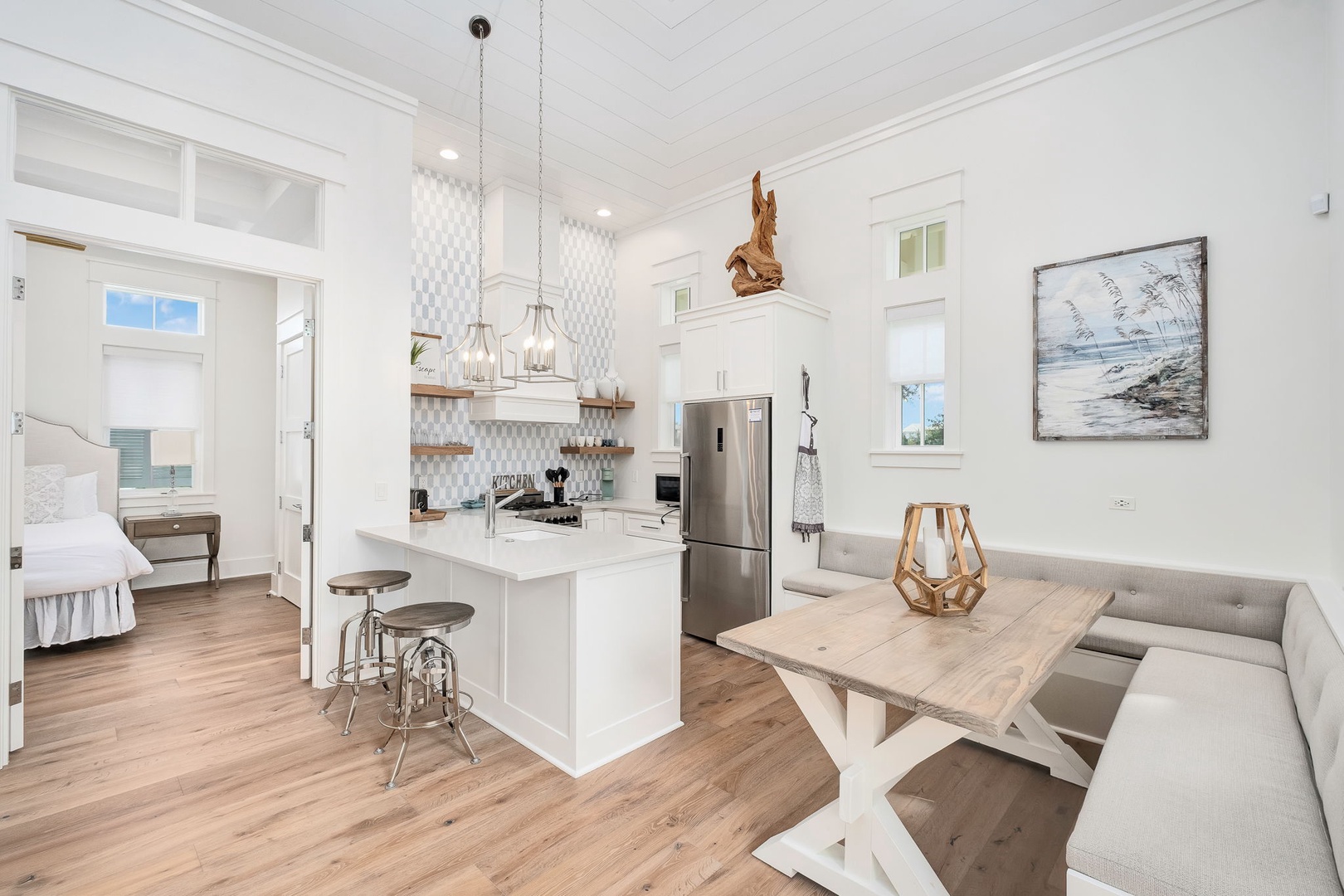 Gather around your coastal dining table or perch at the kitchen island—this bright, airy space invites you to unwind while the sea beckons just beyond the bedroom door.