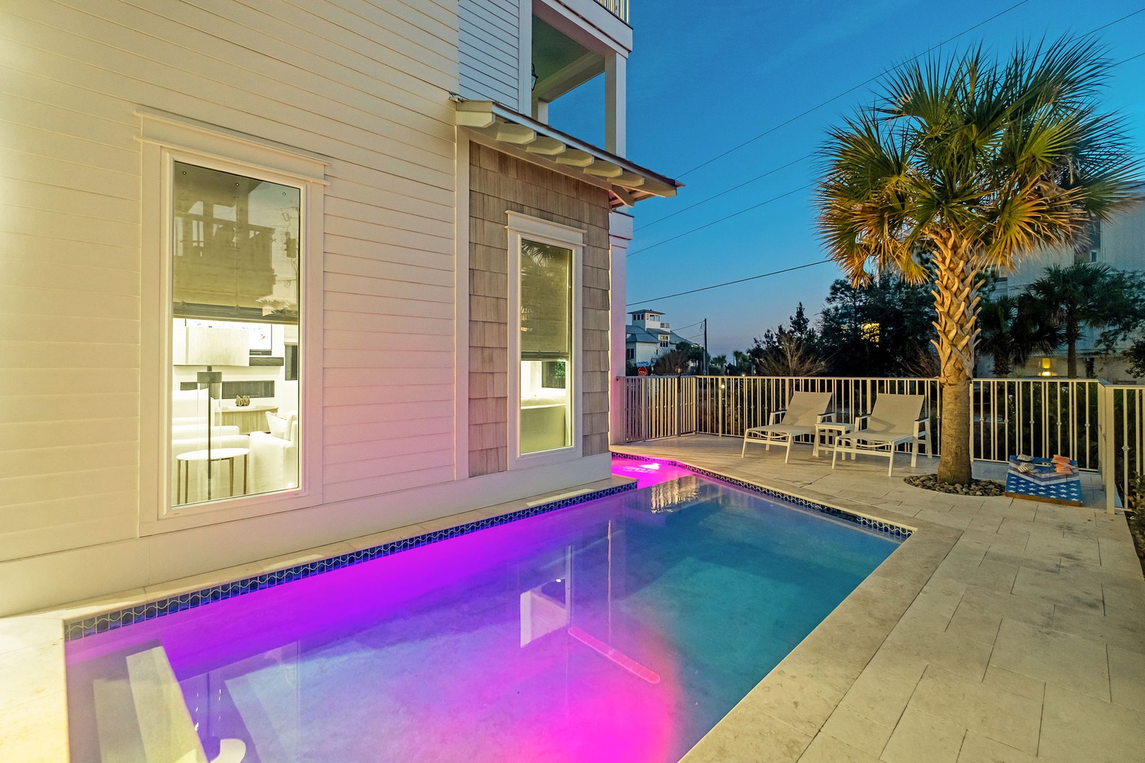 Your private pool glows with vibrant LED lighting creating a magical evening atmosphere. Tropical palm adds to this perfect backyard escape.