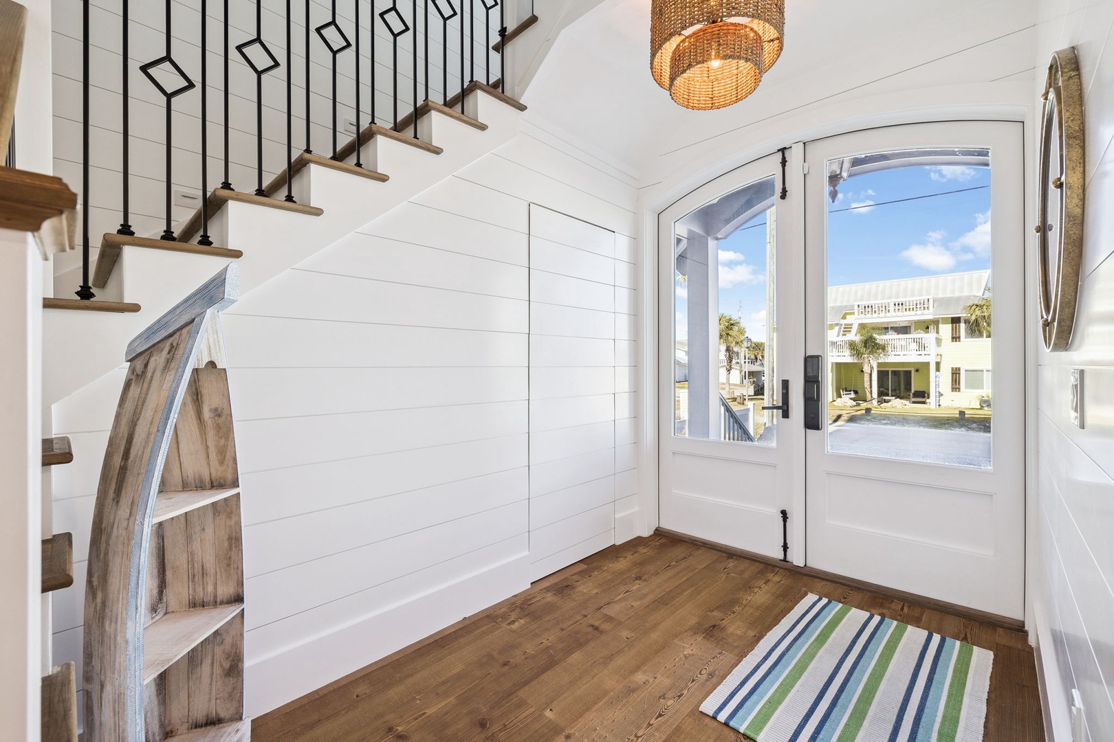 Step into your bright, welcoming entryway where coastal charm meets modern comfort—warm wood floors and stylish design greet you home.