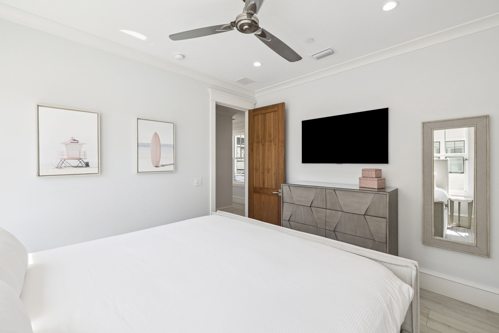 Your serene bedroom features crisp linens, modern furnishings, and thoughtful artwork creating the perfect retreat for restful nights.