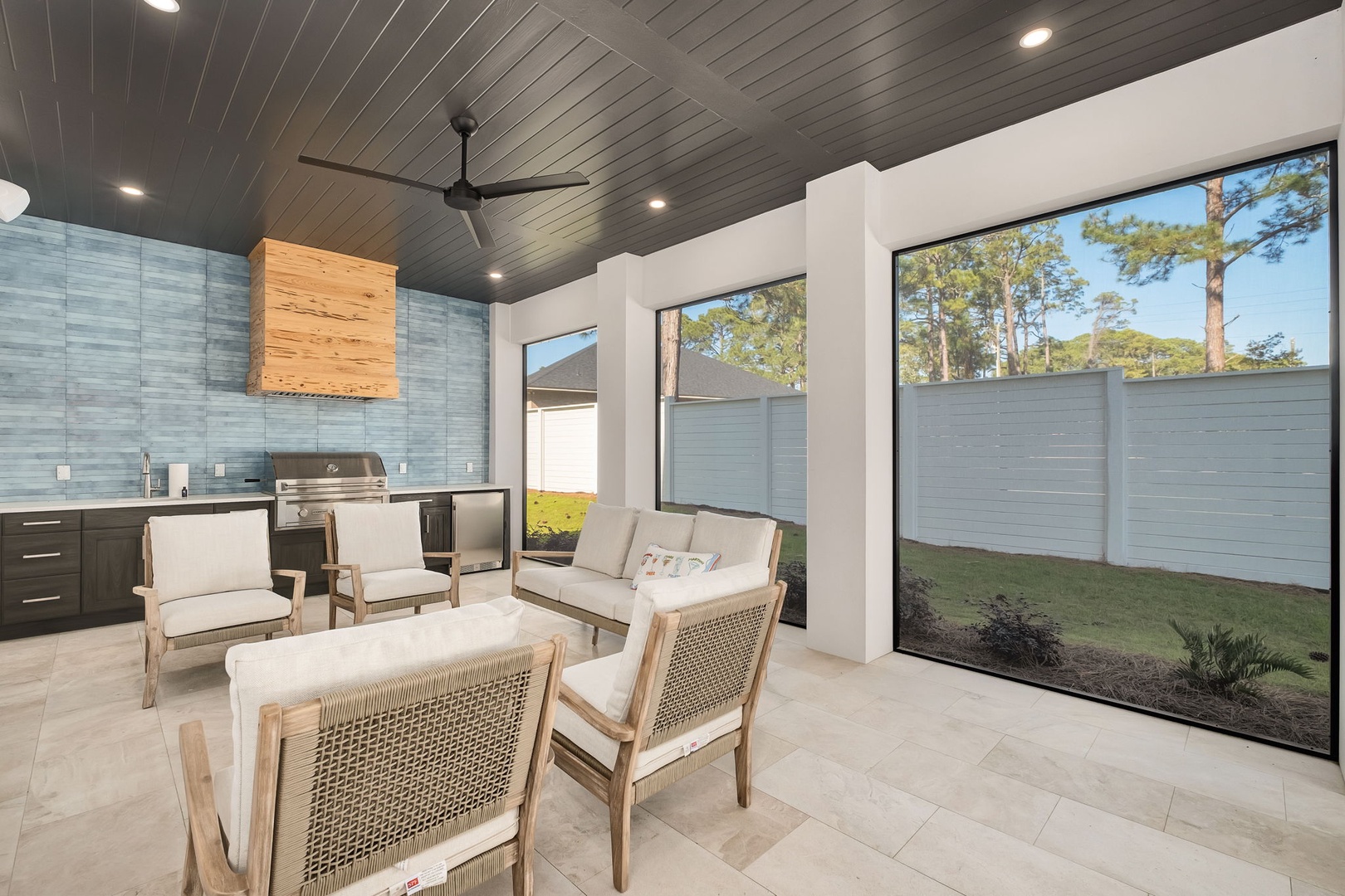 Your covered outdoor kitchen and lounge beckons with modern appliances and comfortable seating, perfect for entertaining while overlooking the private yard.