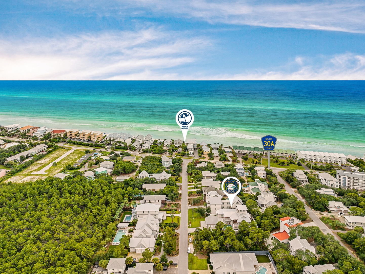 Aerial view of the coastal neighborhood, showcasing the property's prime location near pristine beaches and lush vegetation along scenic Highway 30A.