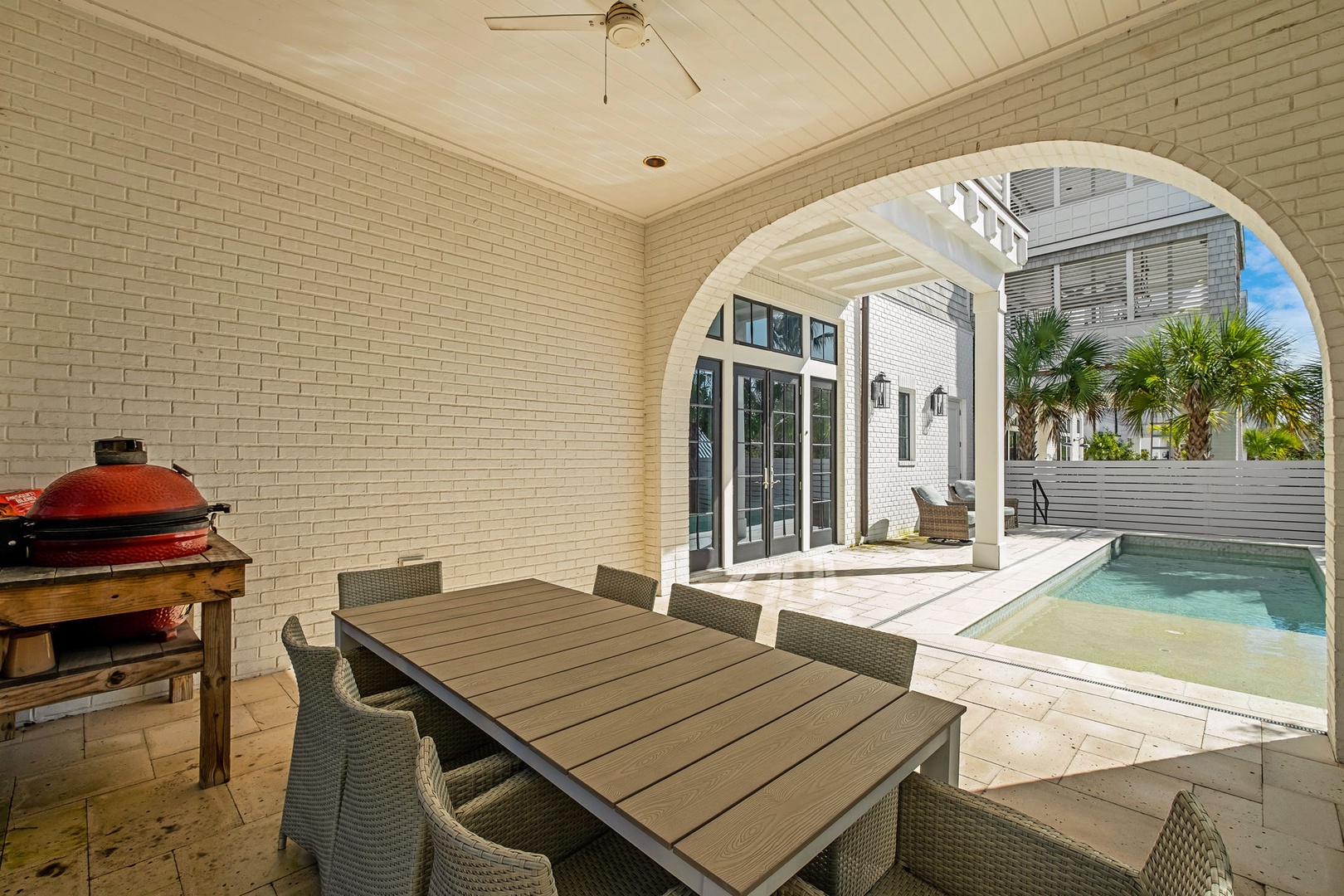 Your covered patio offers the perfect spot for outdoor dining, with a spacious table and BBQ ready for memorable meals.