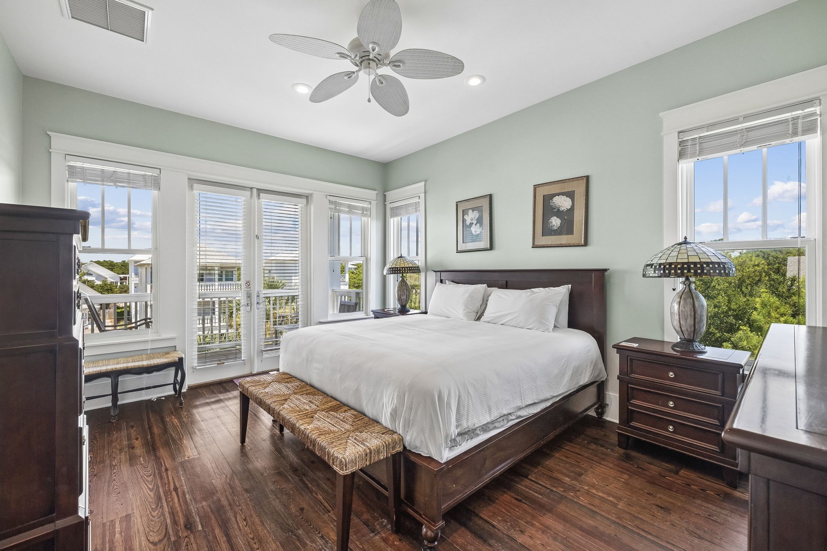 Wake up to peaceful water views from your comfortable bedroom, where soothing colors and gentle breezes through French doors create the perfect escape. Your serene retreat awaits.