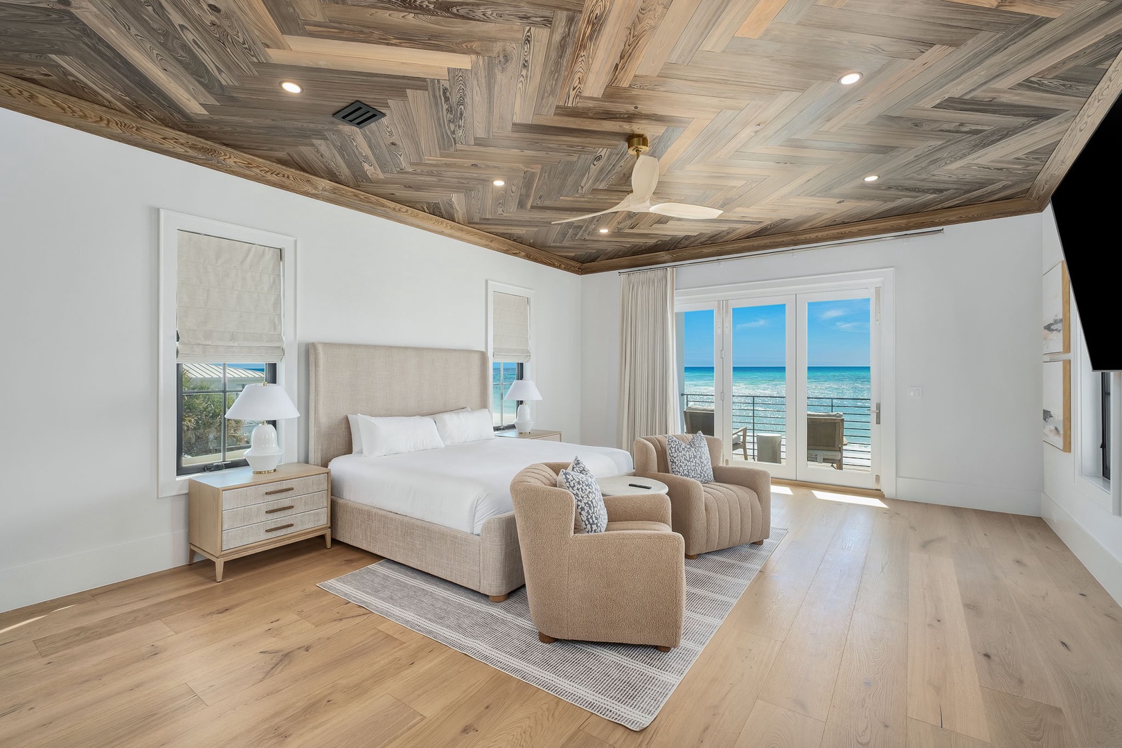 Wake up to stunning ocean views from your spacious master bedroom, featuring elegant coffered ceilings and luxurious furnishings for ultimate relaxation.