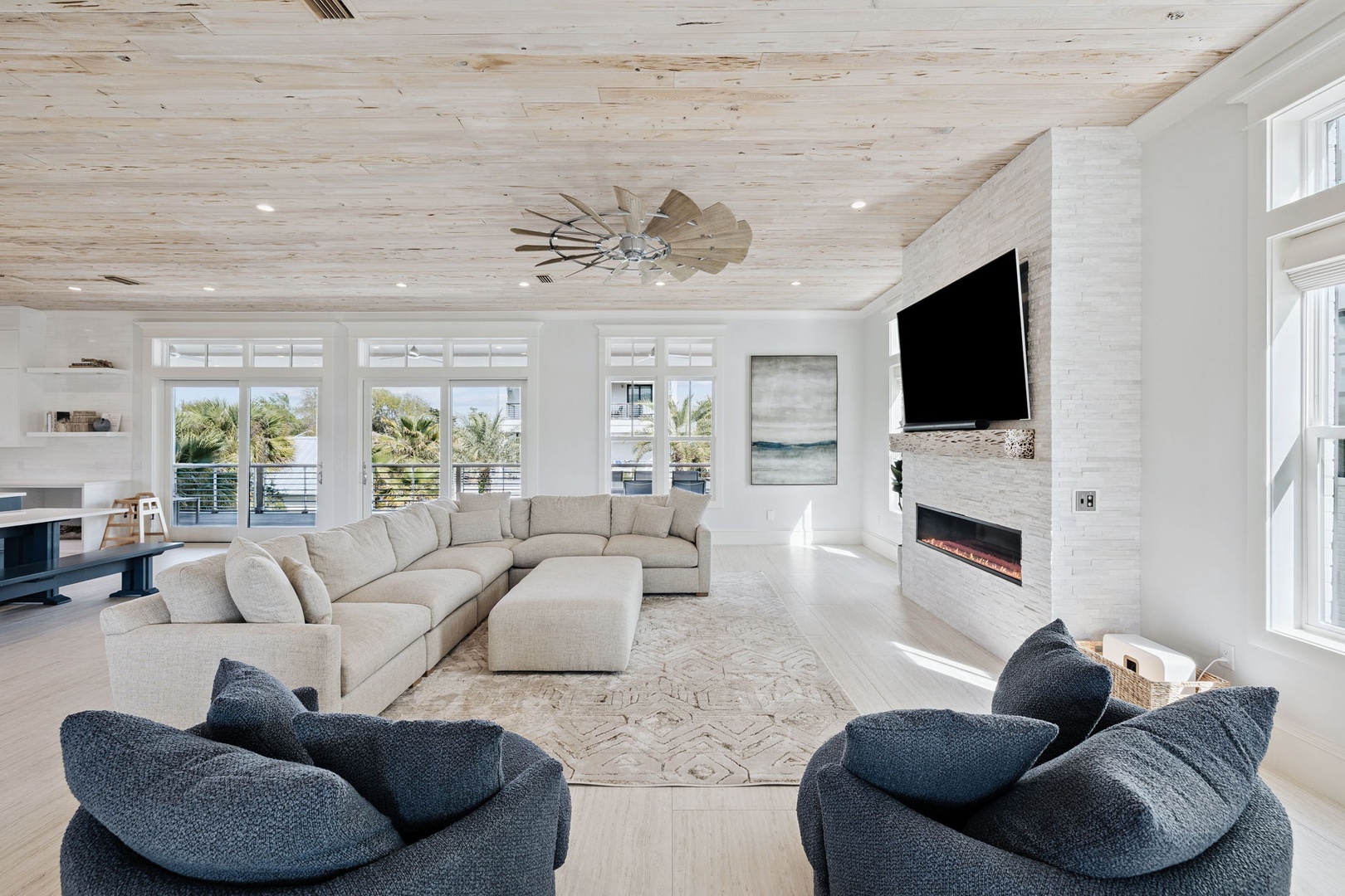 Sink into plush seating surrounded by natural light, where coastal views and modern comfort create your perfect retreat.