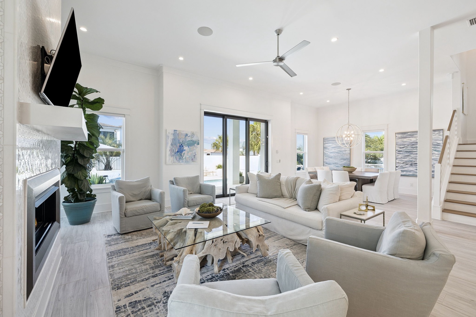 Unwind in your bright, open living space with plush seating, modern fireplace, and seamless indoor-outdoor flow through sliding glass doors.