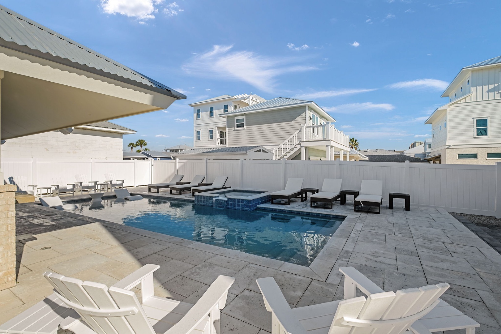 Dive into your private pool paradise with a spa, surrounded by loungers and outdoor seating—perfect for sunny relaxation.