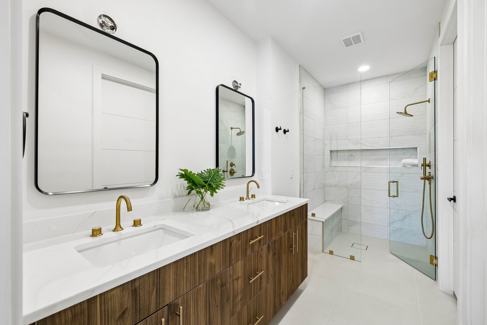 Step into your private spa-like retreat with a luxurious walk-in shower, dual vanities, and elegant gold fixtures—designed for a truly indulgent escape.