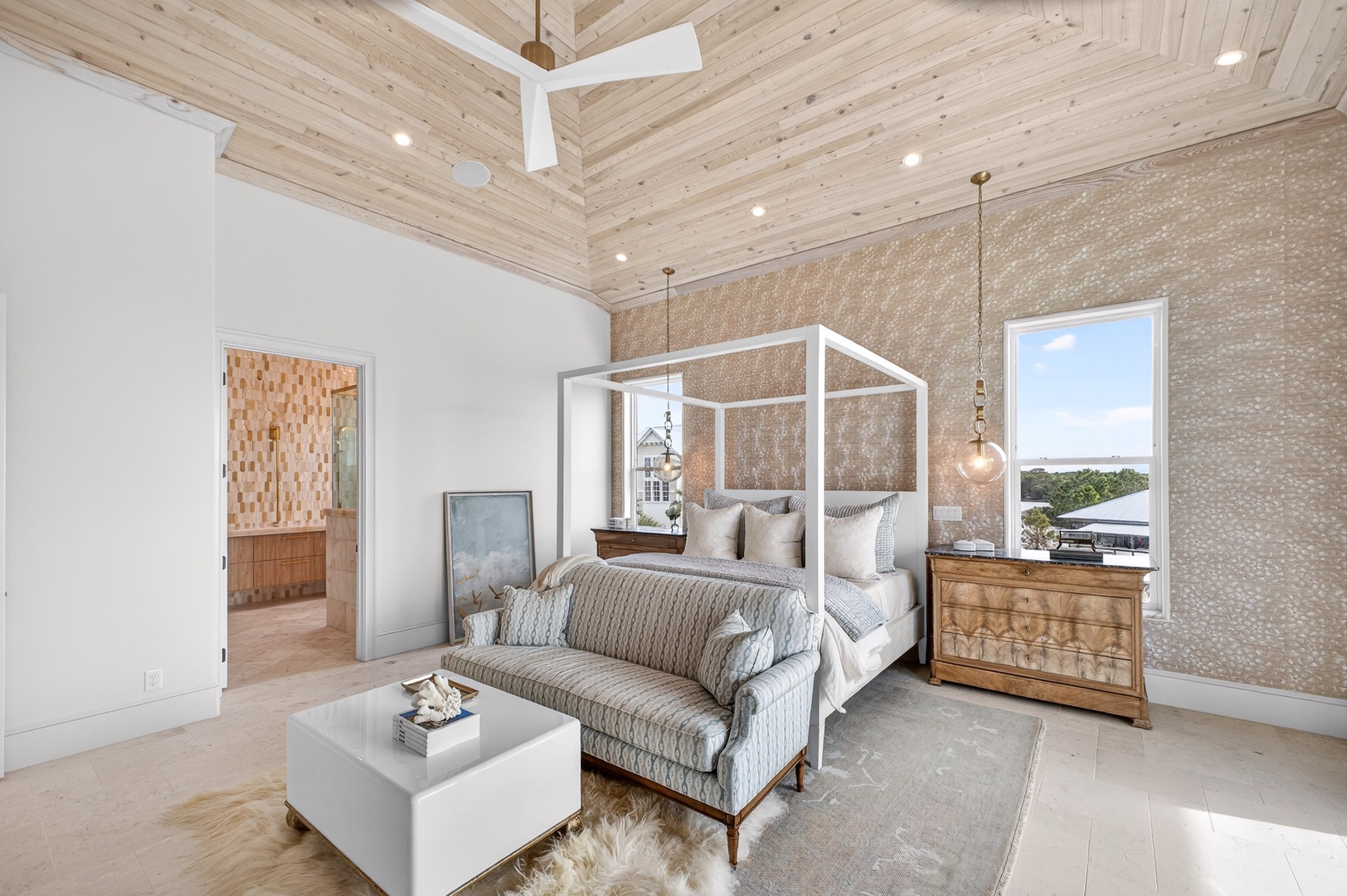 Rest in luxury with your elegant canopy bed, vaulted wood ceiling, and plush seating area perfect for morning coffee.