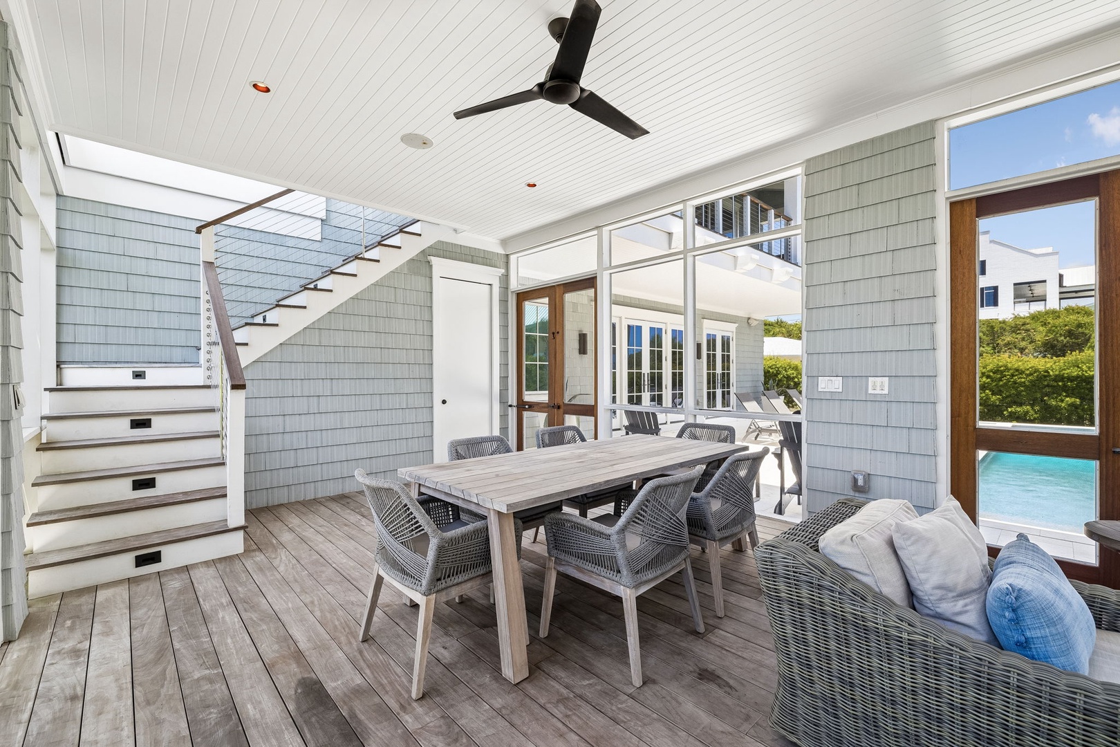 Step into your covered outdoor living space, where a breezy ceiling fan keeps you comfortable while you dine al fresco at the spacious table or lounge with loved ones, all just steps from the sparkling pool.