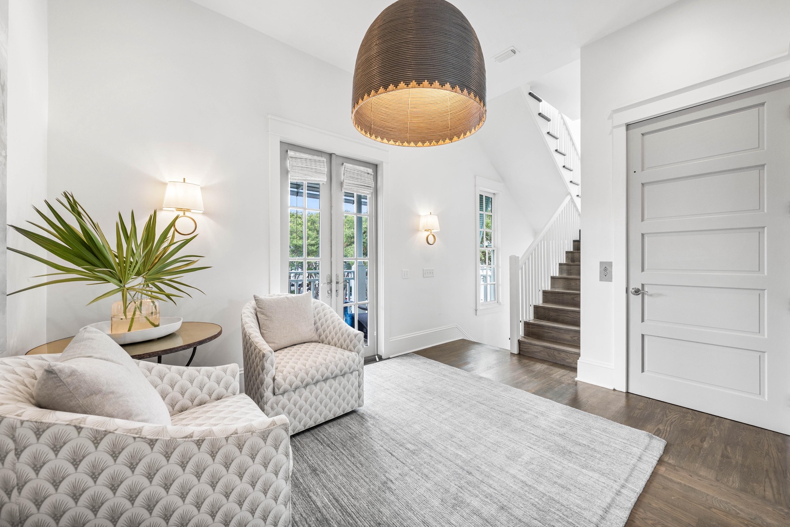 Settle into your elegant seating area with plush textured armchairs and warm lighting, creating the perfect spot to unwind.