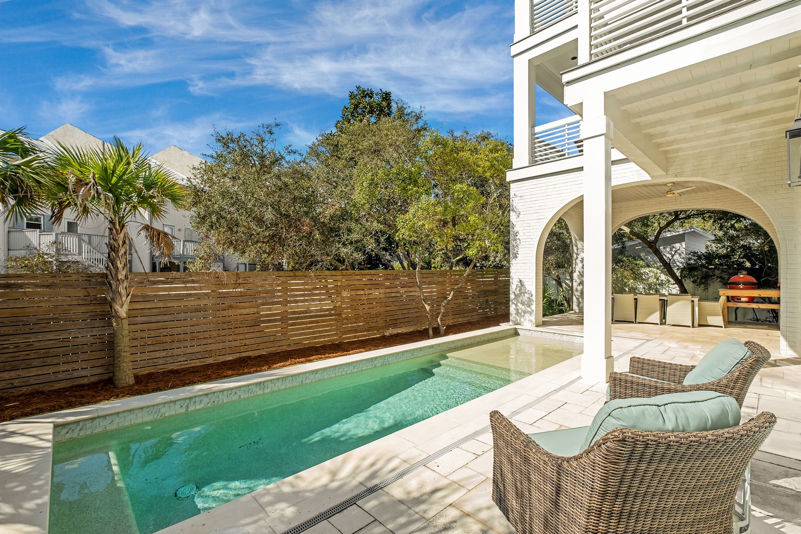 Your private pool oasis awaits with comfortable lounge chairs and covered outdoor dining - perfect for relaxing after sunny Florida beach days.
