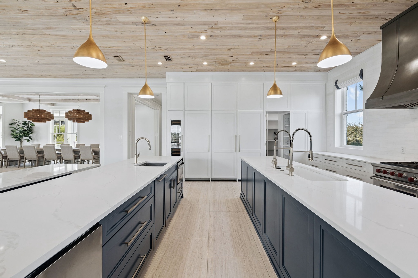 Your modern kitchen features elegant gold pendant lights, spacious marble countertops, and sleek appliances perfect for cooking memorable meals together.