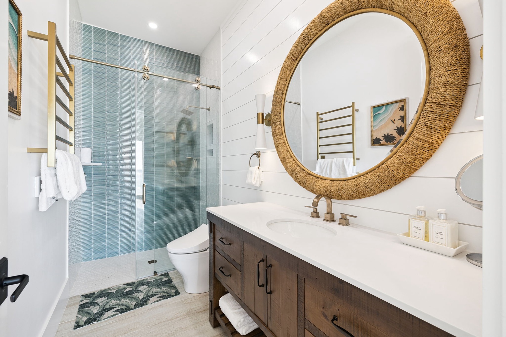 Step into your spa-like retreat with coastal charm—beautiful tile shower, warm wood vanity, and stunning gold mirror create the perfect space to unwind.