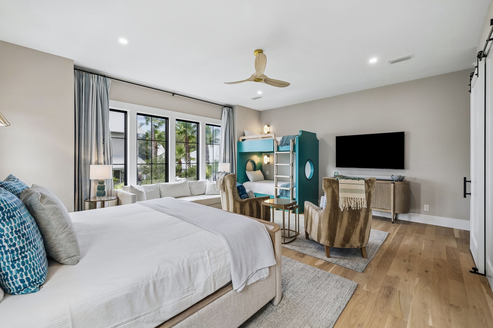 You'll love unwinding in this thoughtfully designed suite, where elegant coastal decor meets playful touches—including a custom bunk nook perfect for the kids—all bathed in natural light from expansive windows.