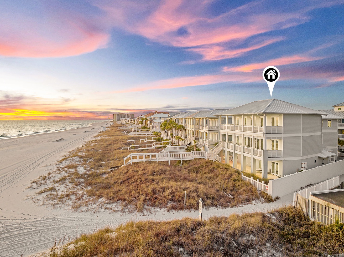 Beachfront property nestled along pristine white sands with stunning coastal views. The building is positioned directly on the shoreline, offering prime beach access and panoramic ocean vistas.
