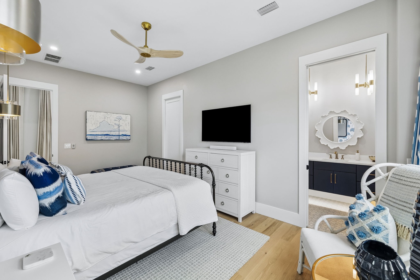 Step into your serene bedroom retreat with coastal-inspired touches, crisp white linens, and a restful ensuite just steps away—perfect for unwinding after a day exploring nearby attractions.
