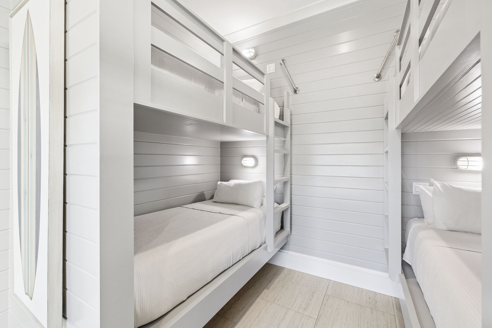 Your bunk room features built-in beds with cozy reading lights and crisp linens, creating a stylish shared space perfect for families.
